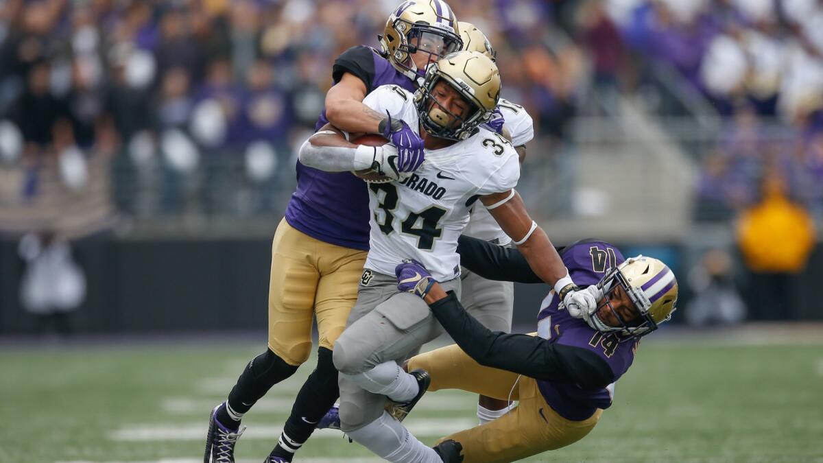 Colorado running back Travon McMillian rushes against Washington at Husky Stadium on Saturday in Seattle.