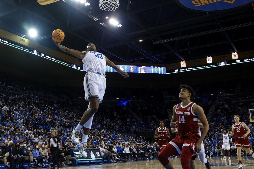UCLA guard Peyton Watson (23) goes up for a dunk-attempt against Stanford in the second half of an NCAA college basketball game Saturday, Jan. 29, 2022, in Los Angeles. (AP Photo/Ringo H.W. Chiu)