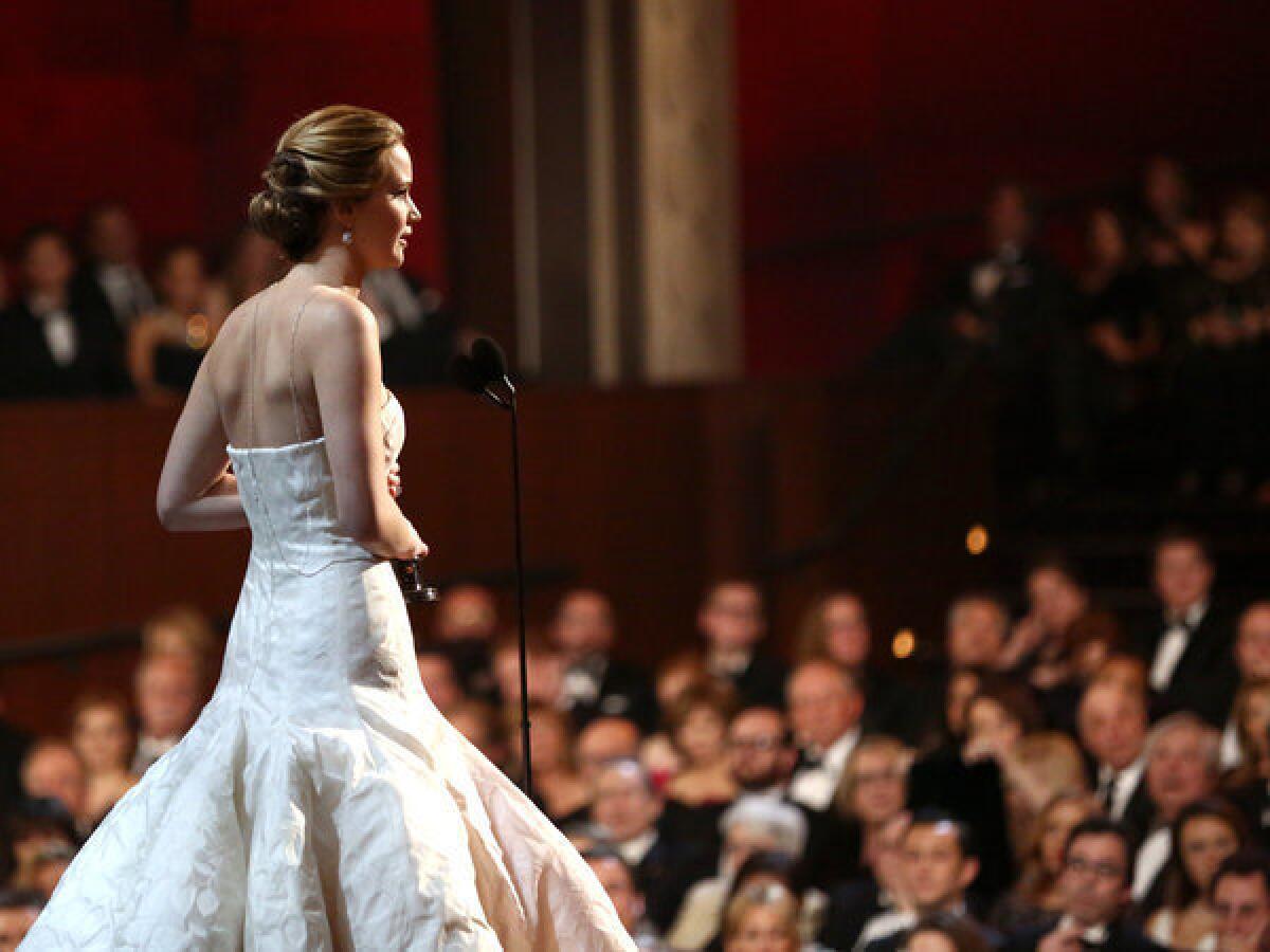 Jennifer Lawrence accepts the award for best actress in a leading role for "Silver Linings Playbook" during the Oscars.