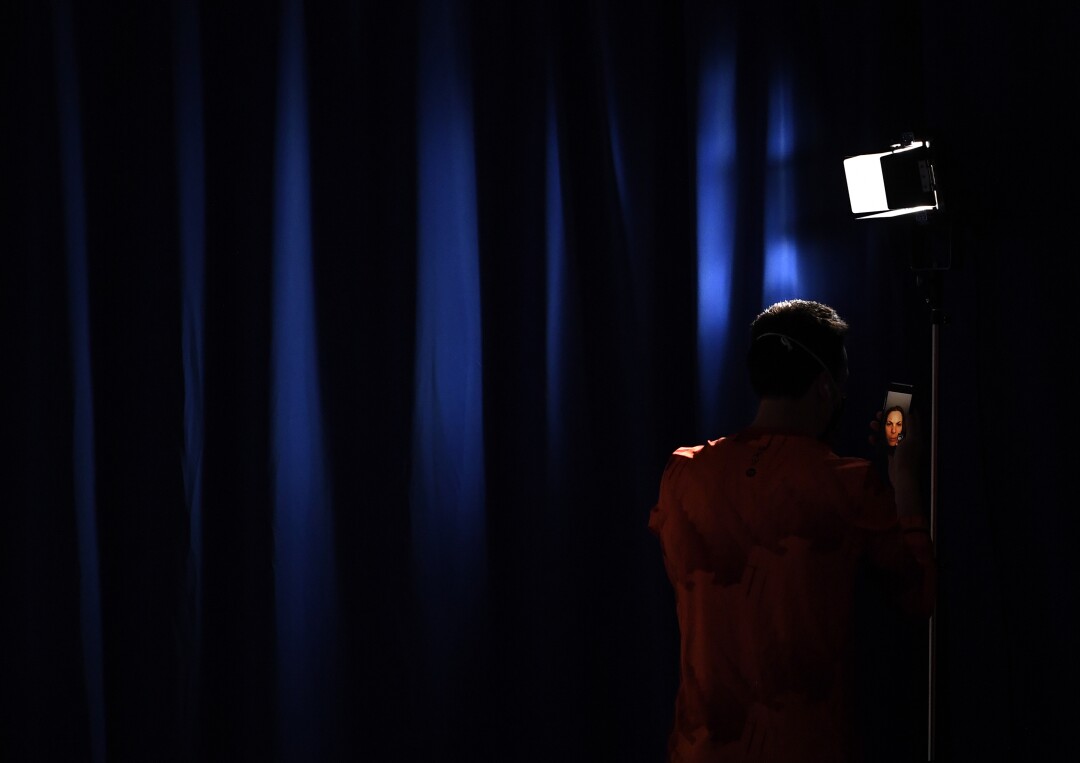 A member of the German team takes a selfie before the men's synchronized 3m springboard final