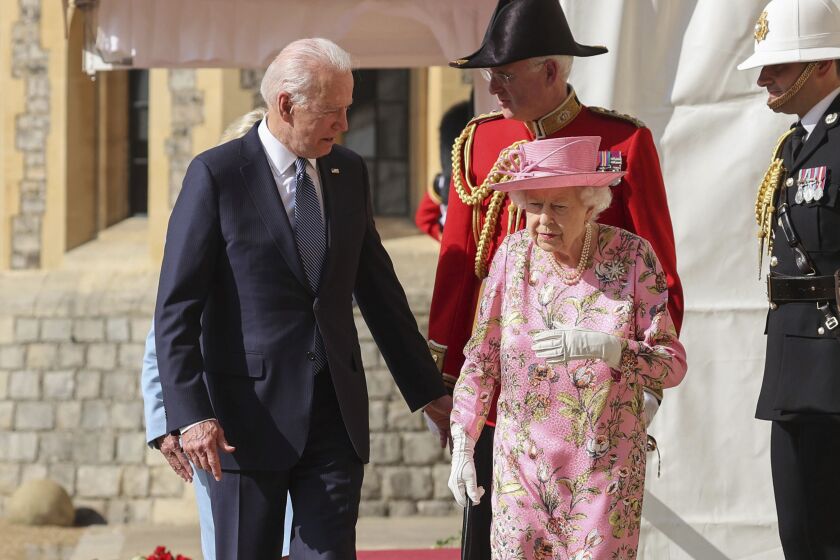 Britain's Queen Elizabeth II, right, walks with US President Joe Biden during his visit to Windsor Castle, near London, Sunday June 13, 2021. (Chris Jackson/Pool Photo via AP)
