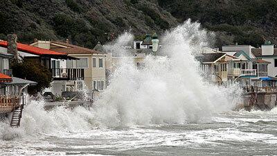 Waves hit the breakwall behind homes on Pacific Coast Highway between Faria Road and Solimar Beach Road in Ventura County.