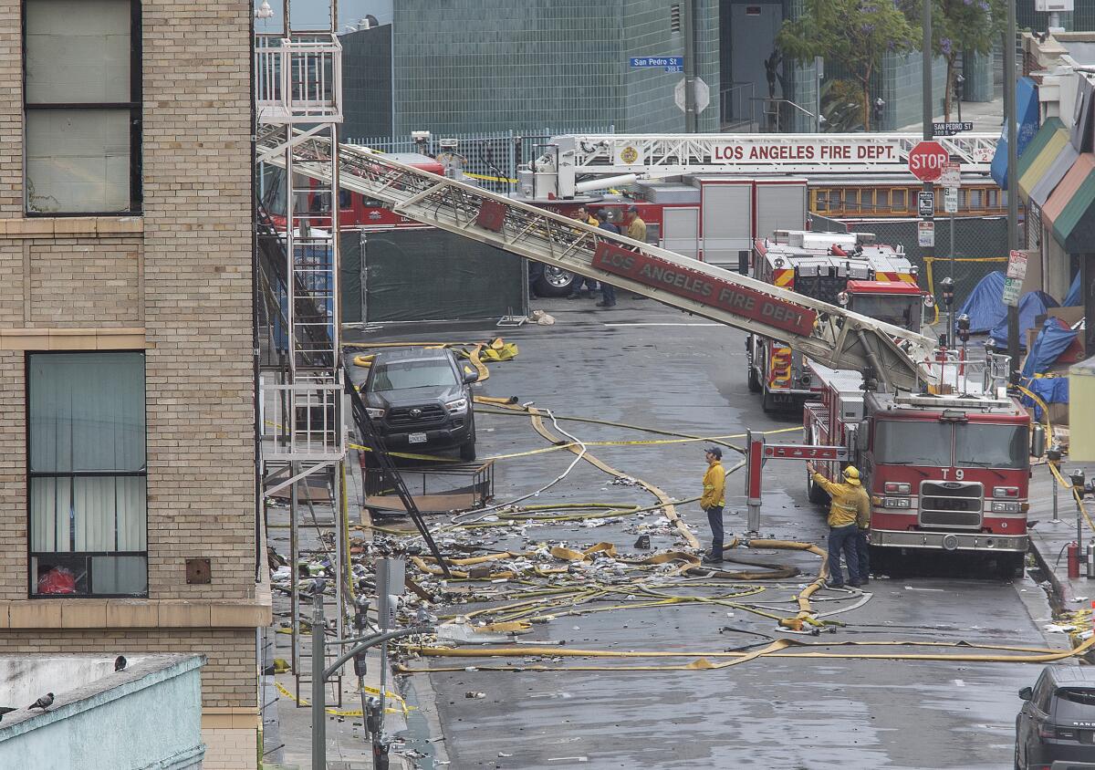 The Los Angeles Fire Department investigates the scene of a fiery explosion on Boyd Street in May 2019.