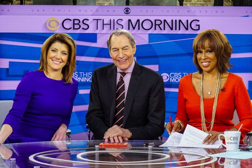 This Dec. 7, 2016 image released by CBS shows, from left, Norah O'Donnell, Charlie Rose and Gayle King on the set of "CBS This Morning," in New York. (Michele Crowe/CBS via AP)