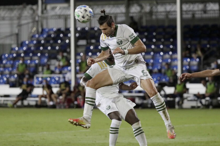 Portland Timbers midfielder Diego Valeri heads the ball against the New York City during the second half of an MLS soccer match, Saturday, Aug. 1, 2020, in Kissimmee, Fla. (AP Photo/John Raoux)