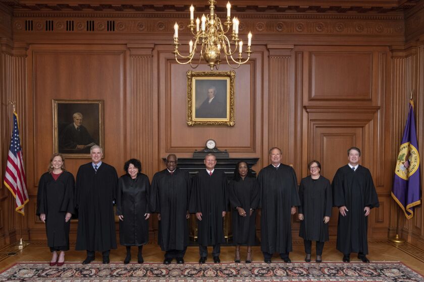 In this image provided by the Supreme Court, members of the Supreme Court pose for a photo during Associate Justice Ketanji Brown Jackson's formal investiture ceremony at the Supreme Court in Washington, Friday, Sept. 30, 2022. From left, Associate Justice Amy Coney Barrett, Associate Justice Neil Gorsuch, Associate Justice Sonia Sotomayor, Associate Justice Clarence Thomas, Chief Justice John Roberts, Associate Justice Ketanji Brown Jackson, Associate Justice Samuel Alito, Associate Justice Elena Kagan and Associate Justice Brett Kavanaugh. (Fred Schilling/U.S. Supreme Court via AP)