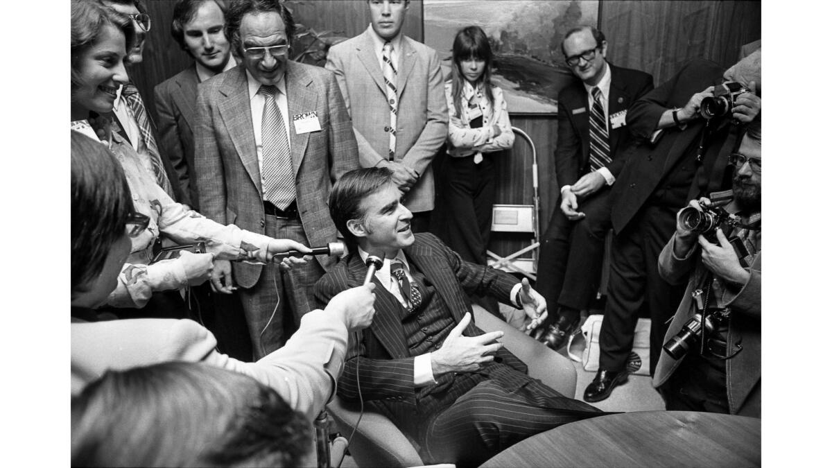 Nov. 6, 1974: Gov.-elect Jerry Brown talks with reporters at his campaign headquarters in Los Angeles shortly before giving his victory speech.