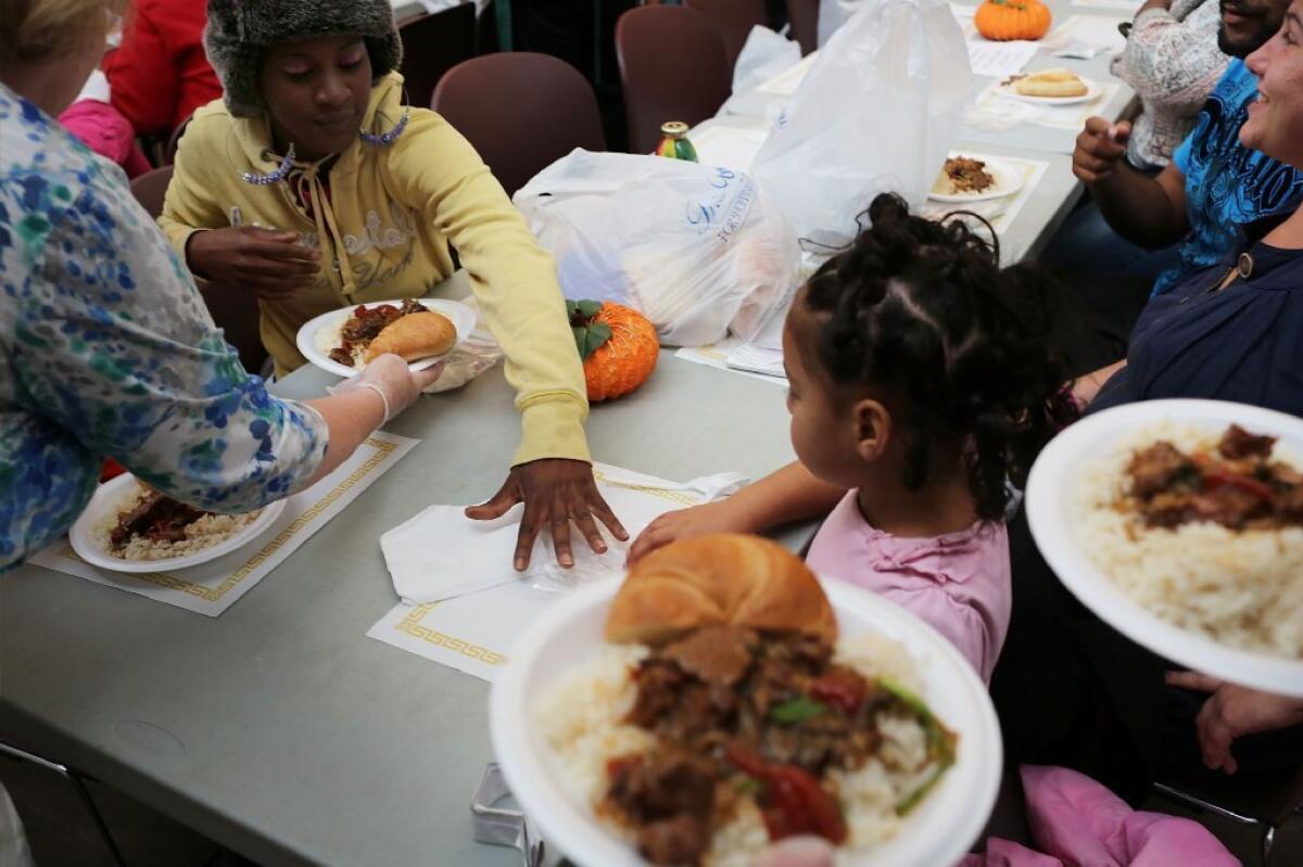 People eat dinner at the Cathedral Kitchen soup kitchen which serves 300 to 600 meals a day, six days a week, to the needy and hungry in Camden, New Jersey. Poor people may think differently about their resources than the rich, a new study finds.