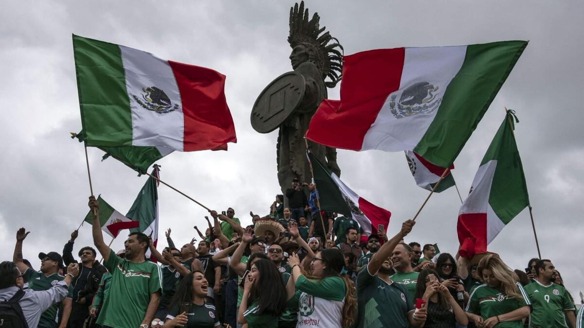 Mexican fans gather to celebrate Mexico's victory against Germany in their first 2018 World Cup football match, at the Cuauhtemoc monument in Tijuana, Baja California state, Mexico.