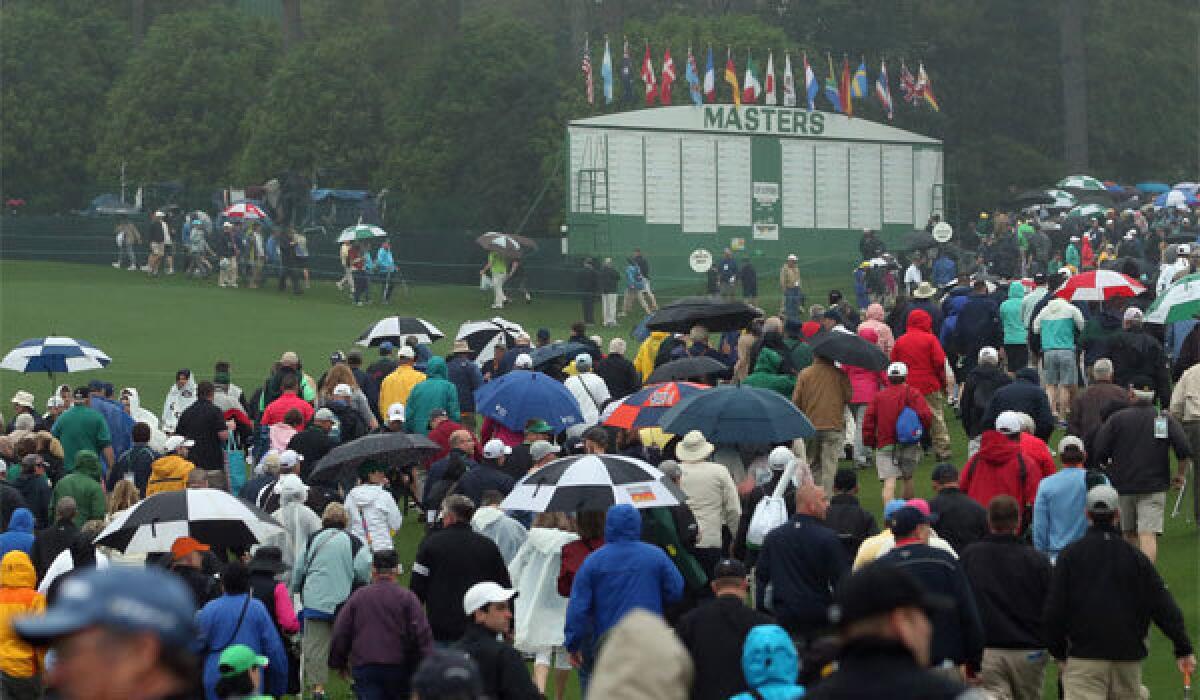 Patrons are evacuated from the Augusta National Golf Club course after play was suspended due to severe weather during a practice round for the Masters.