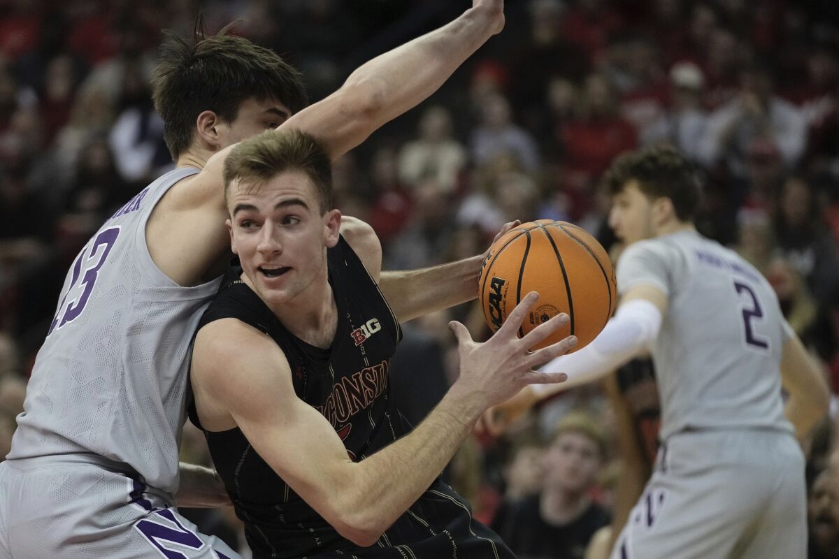 Wisconsin's Tyler Wahl tries to get past Northwestern's Brooks Barnhizer during the second half of an NCAA college basketball game Sunday, Feb. 5, 2023, in Madison, Wis. (AP Photo/Morry Gash)