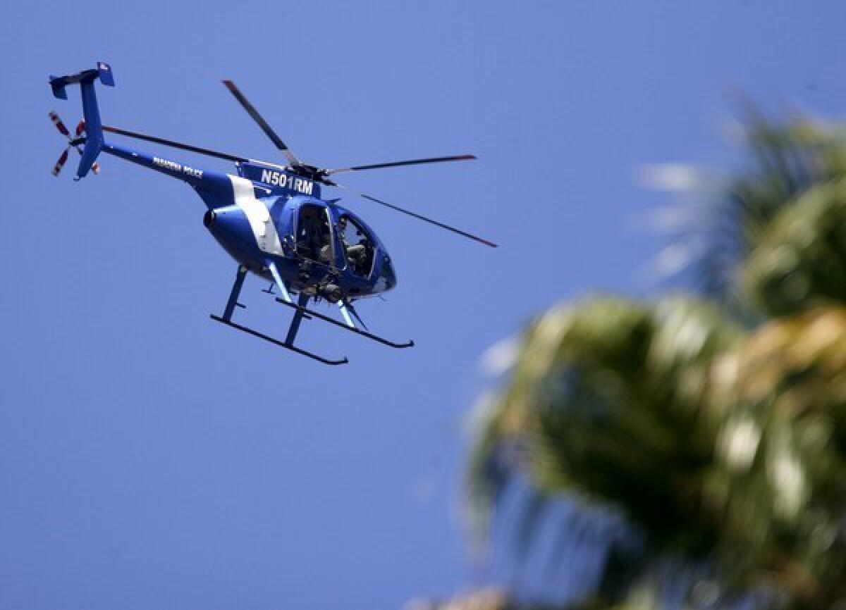 Glendale Police Dept. helicopter officers look for a burglary suspect above and nearby Brand Park in Glendale on Thursday, Sept. 13, 2012.