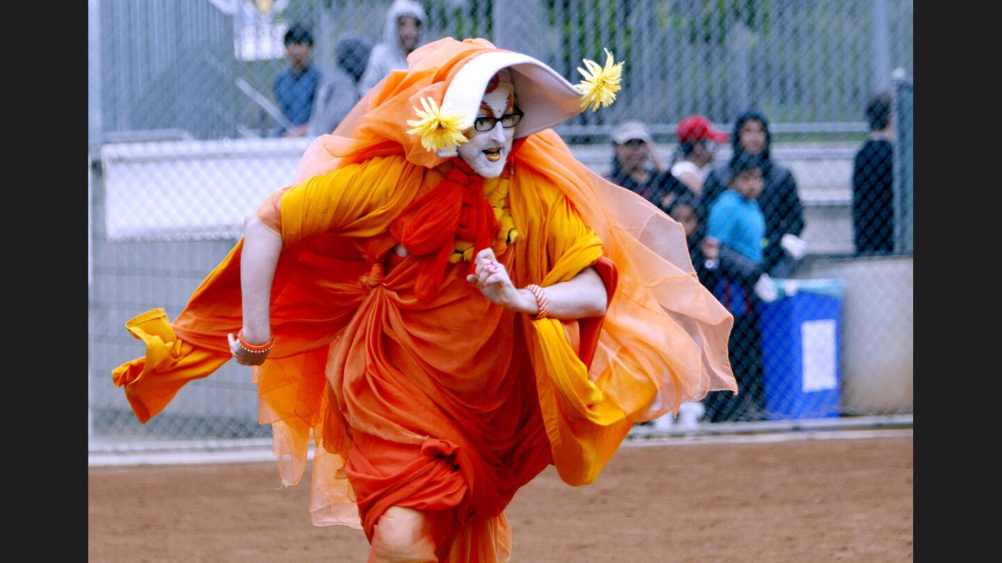 Sister Unity of the Sisters of Perpetual Indulgence team races to first base after hitting the ball in softball game vs. the West Hollywood Cheerleaders in the 6th Annual Drag Queen World Series at Glendale Sports Complex, in Glendale on Saturday, May 6, 2017. The charity event was held to benefit The Life Group L.A., a coalition of people dedicated to the education, empowerment and emotional support of persons both infected and affected by HIV/AIDS.