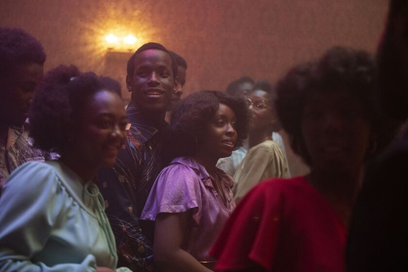 Micheal Ward as Franklyn (center left) and Amarah-Jae St. Aubyn as Martha (purple dress) in Lovers Rock. Credit: Parisa Taghizedeh / Amazon Prime Video