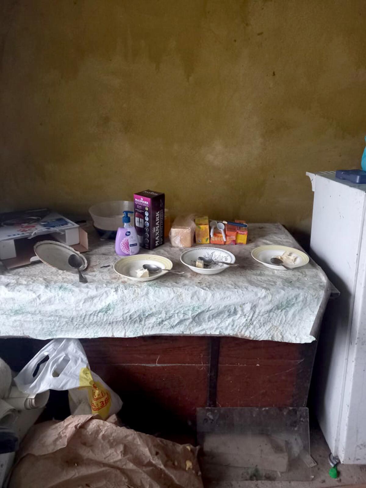 A makeshift table holds three bowls of food for Tatyana, her daughter and her boyfriend in the underground shelter.