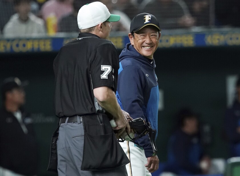 Hideki Kuriyama, then manager of the Nippon-Ham Fighters, speaks to an umpire during an exhibition game March 17, 2019.