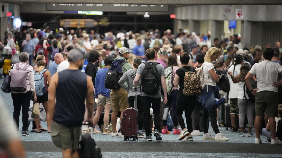 Crowds of people fill the Kahului Airport.