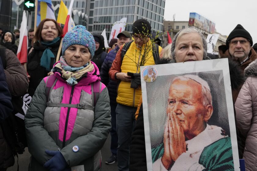 People take part in a march in defense of the late pope, St. John Paul II, in Warsaw, Poland, Sunday April 2, 2023. The march, organized by an anti-abortion group, is being held in the wake of investigative reports alleging that John Paul covered up clerical sex abuse of minors in Poland in the 1970s when he was still Karol Wojtyla, an archbishop in his native Poland. The march takes place on the 18th anniversary of the pope's death. (AP Photo/Czarek Sokolowski)