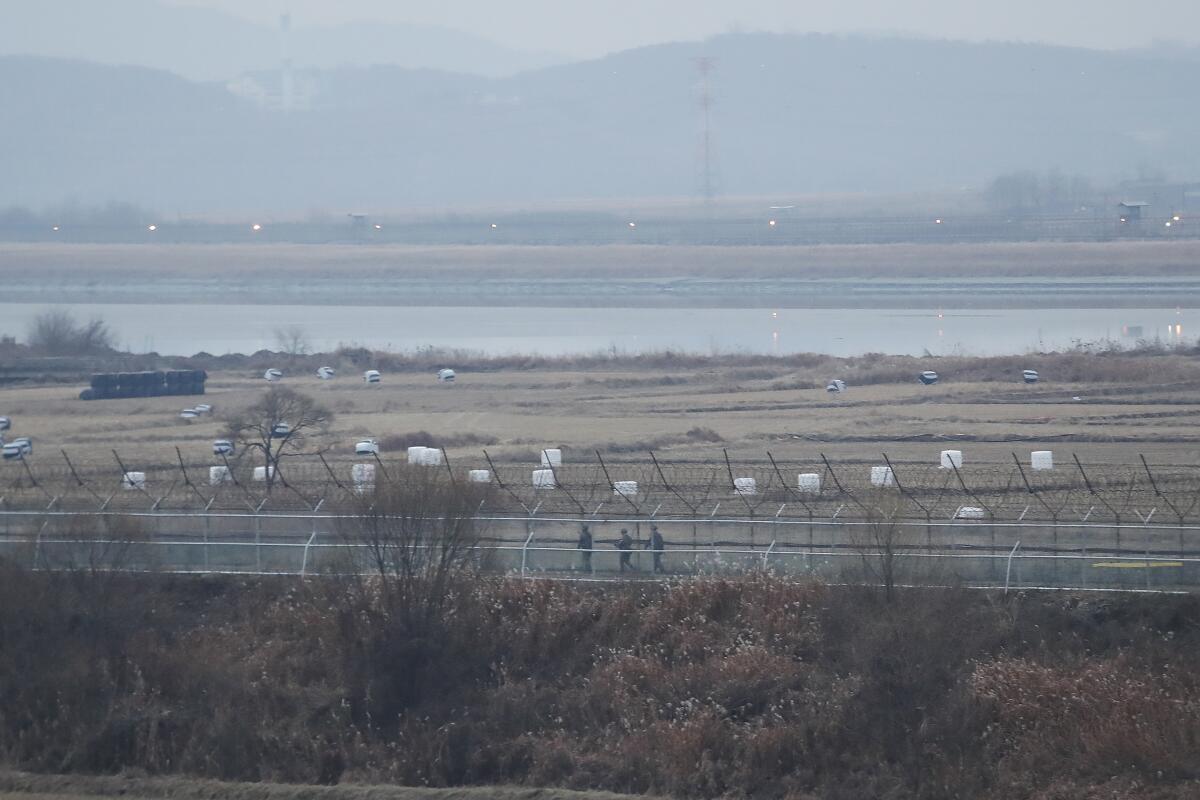 South Korean army soldiers patrol along the barbed-wire fence in Paju, South Korea, near the border with North Korea on Dec. 16, 2019. 