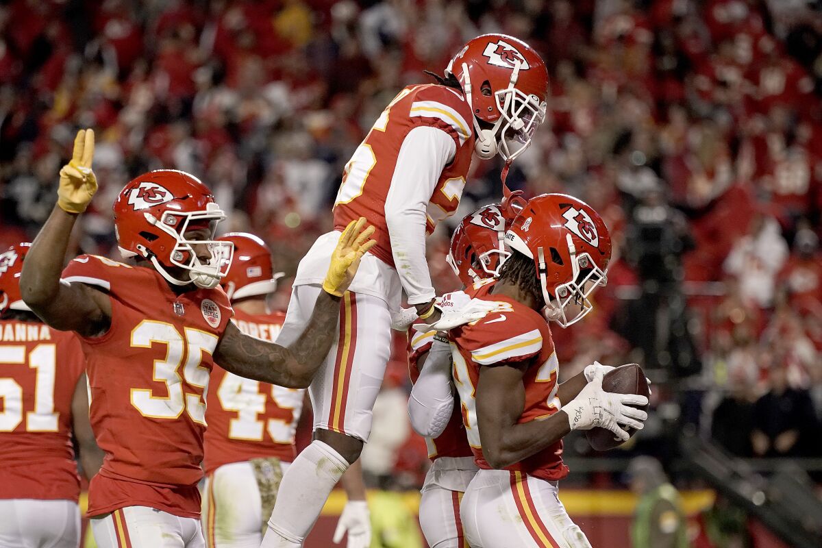 Kansas City Chiefs cornerback L'Jarius Sneed, right, celebrates with teammates after catching an interception late in the second half of an NFL football game against the Dallas Cowboys, Sunday, Nov. 21, 2021, in Kansas City, Mo. The Chiefs won 19-9. (AP Photo/Charlie Riedel)
