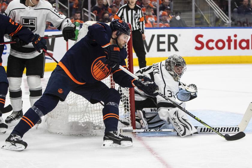 Los Angeles Kings goalie Jonathan Quick (32) makes a save against Edmonton Oilers' Leon Draisaitl, front, during the second period of Game 2 of an NHL hockey Stanley Cup playoffs first-round series Wednesday, May 4, 2022, in Edmonton, Alberta. (Jason Franson/The Canadian Press via AP)