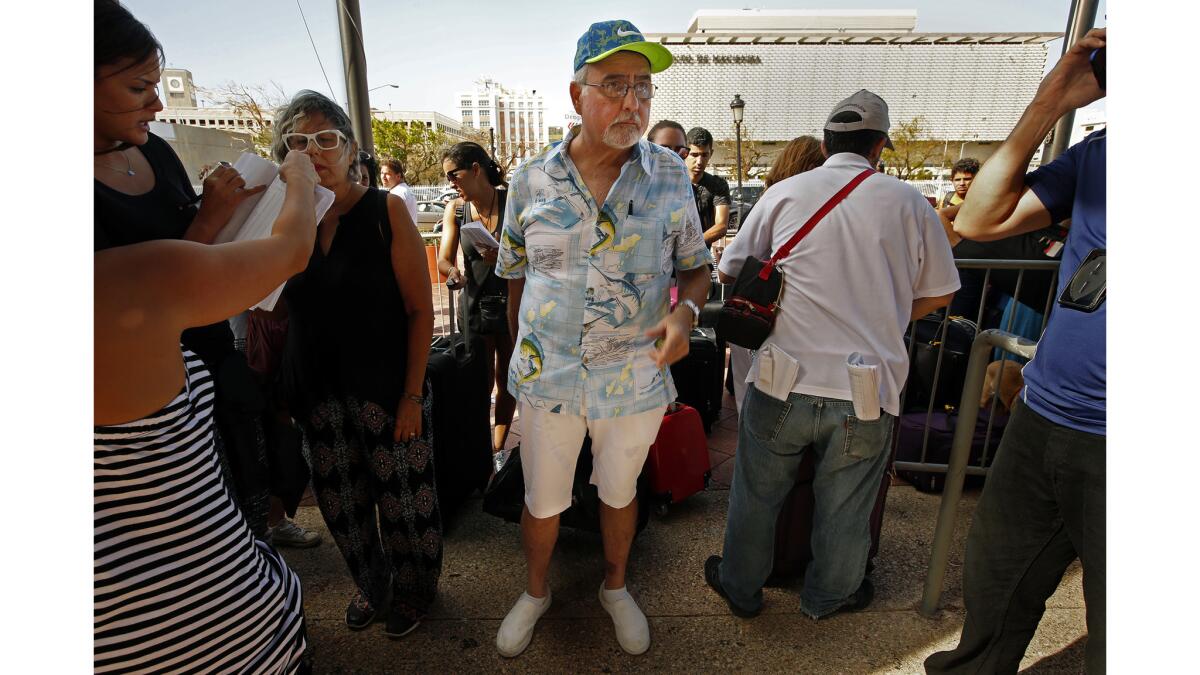 Luis Frankie, 66, waits to board an evacuation cruise ship in San Juan.