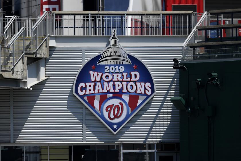 A 2019 World Series champions sign is displayed during the Washington Nationals baseball practice at Nationals Park, Wednesday, July 22, 2020, in Washington. (AP Photo/Nick Wass)