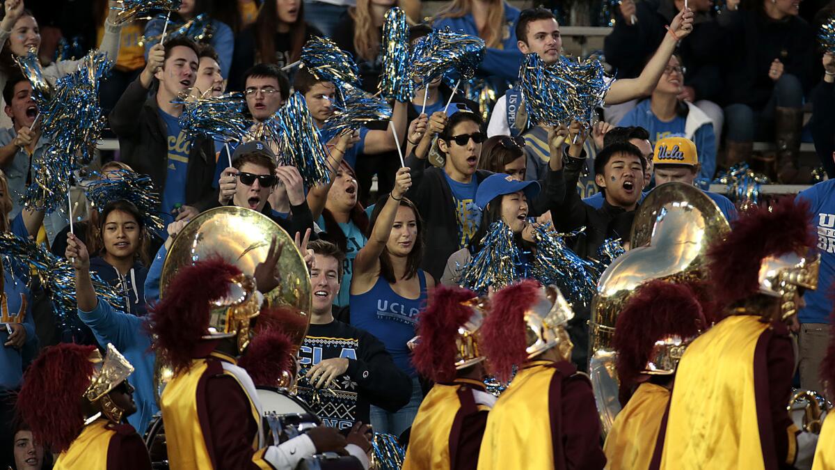 UCLA students give some USC band members a little grief during the rivalry game at the Rose Bowl in 2014.