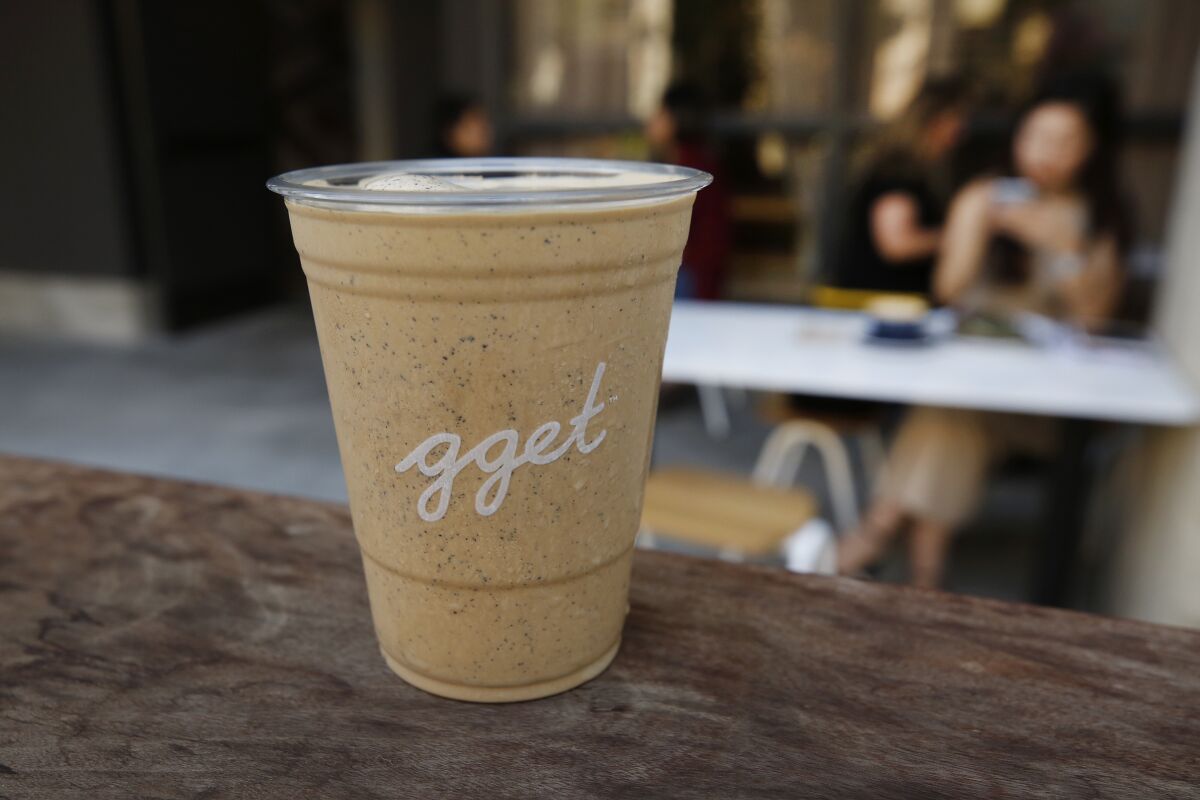A coffee milkshake in a clear plastic glass from Go Get Em Tiger