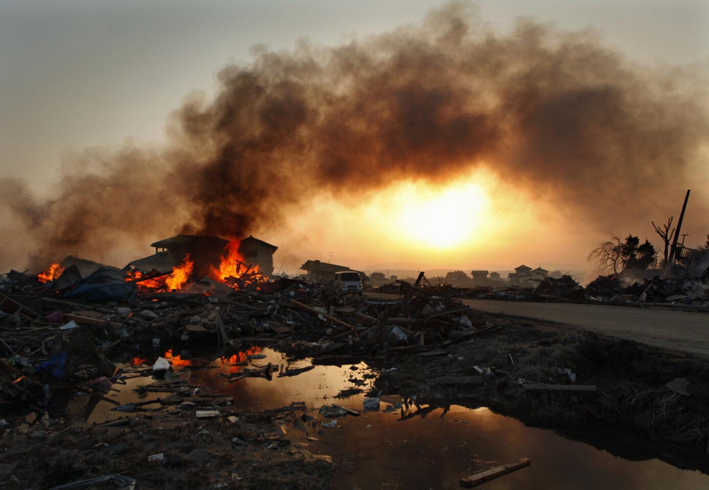 The Natori area of Sendai, Japan, was completely destroyed by the March 2011 tsunami that followed a powerful offshore earthquake. Fires burned in the neighborhood as civil servants finally were able to enter the area to look for the dead.