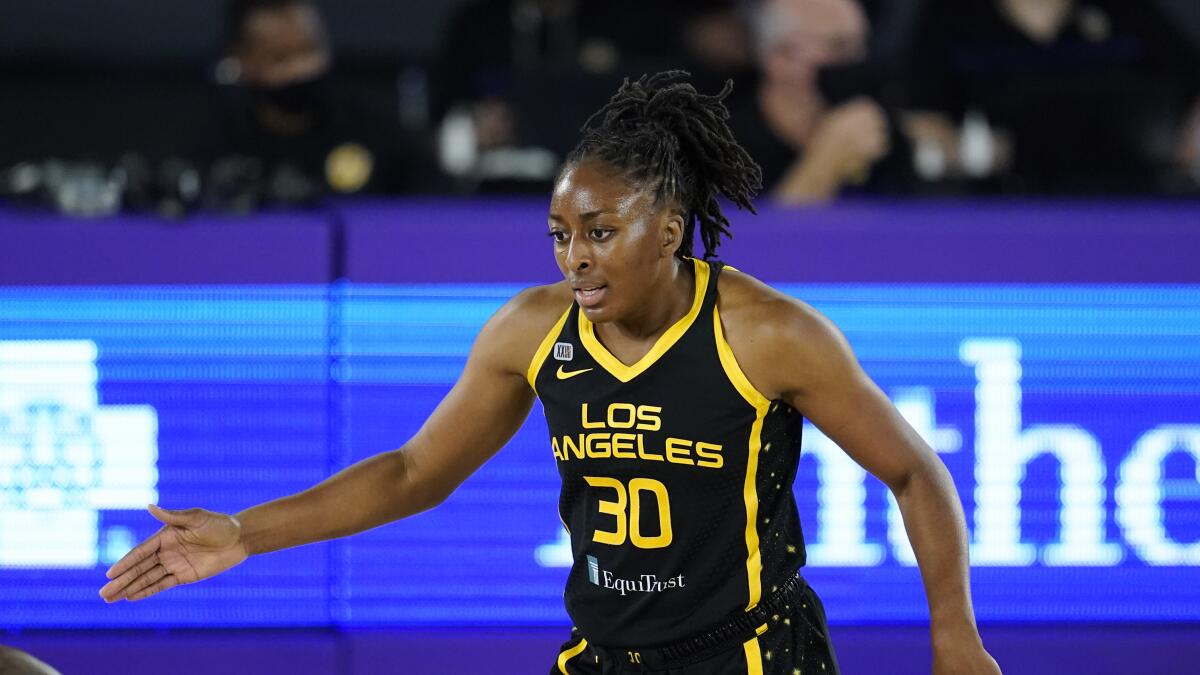 Sparks forward Nneka Ogwumike talks to a teammate during a game.