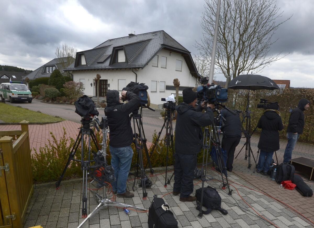 Journalists stand outside the house in the German town of Montabaur where Germanwings copilot Andreas Lubitz used to live.