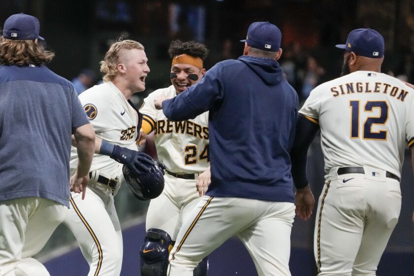 Milwaukee Brewers' Joey Wiemer is congratulated after hitting a walk-off RBI single during the 10th inning of a baseball game against the Baltimore Orioles Tuesday, June 6, 2023, in Milwaukee. The Brewers won 4-3. (AP Photo/Morry Gash)