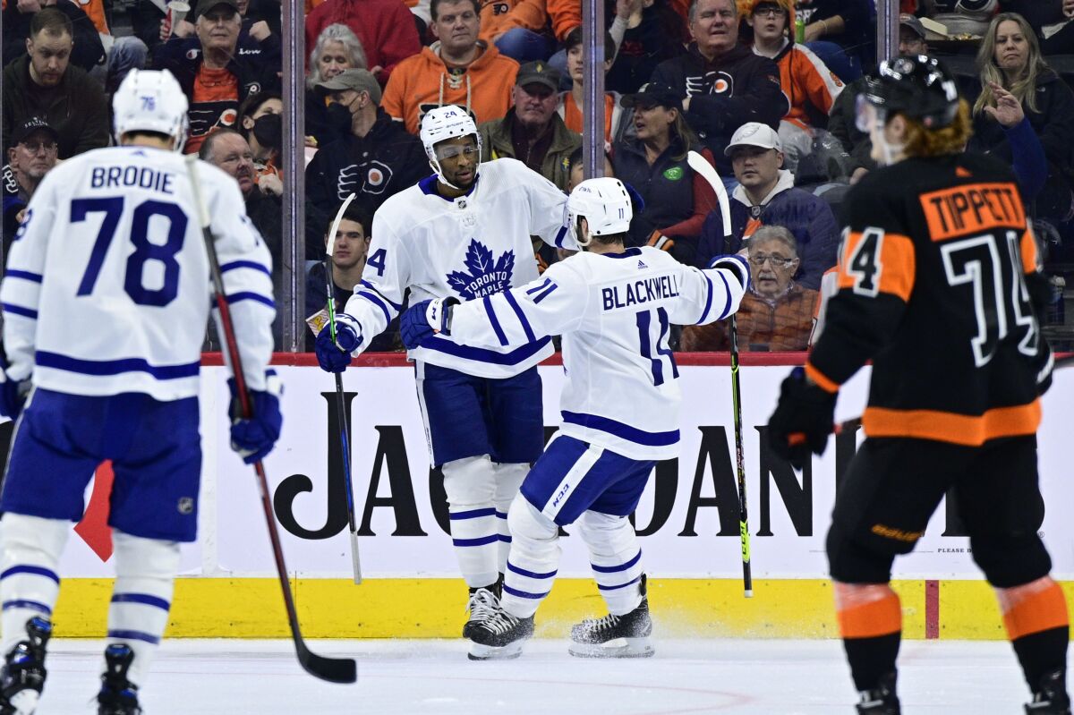 Toronto Maple Leafs' Wayne Simmonds, second from left, celebrates his goal with Colin Blackwell (11) during the second period of an NHL hockey game against the Philadelphia Flyers, Saturday, April 2, 2022, in Philadelphia. (AP Photo/Derik Hamilton)