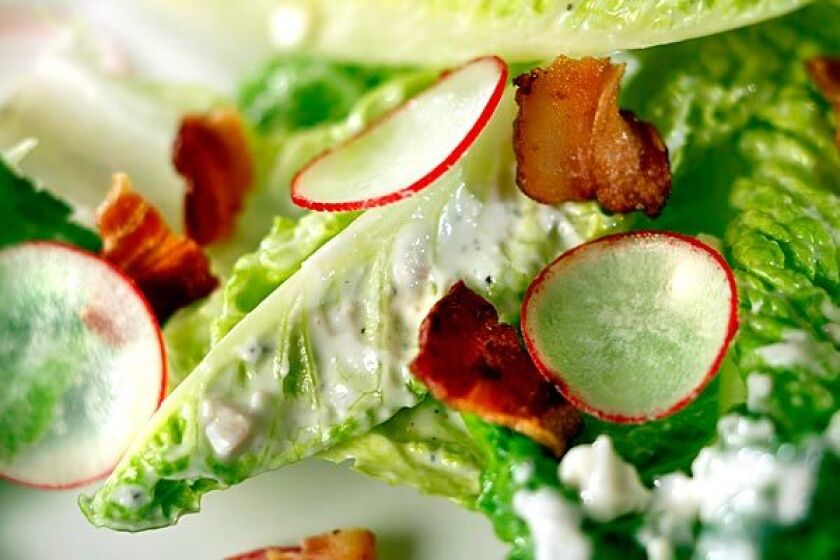 Romaine salad with bacon, homemade blue cheese dressing and radishes.