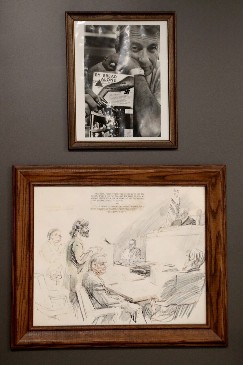 A photo of Holocaust survivor Mel Mermelstein above a sketch of Holocaust deniers in an exhibit at the Chabad Center.