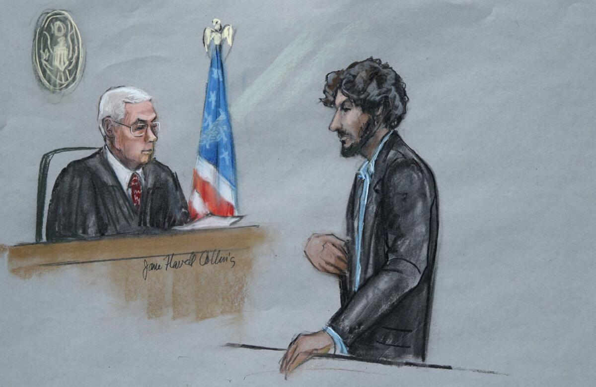 In this courtroom sketch, Boston Marathon bomber Dzhokhar Tsarnaev, right, stands before U.S. District Judge George O'Toole Jr. as he addresses the court during his sentencing.
