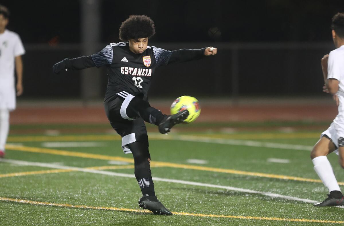 Estancia's Brandon Garcia (12) shoots and scores from the box on Friday.