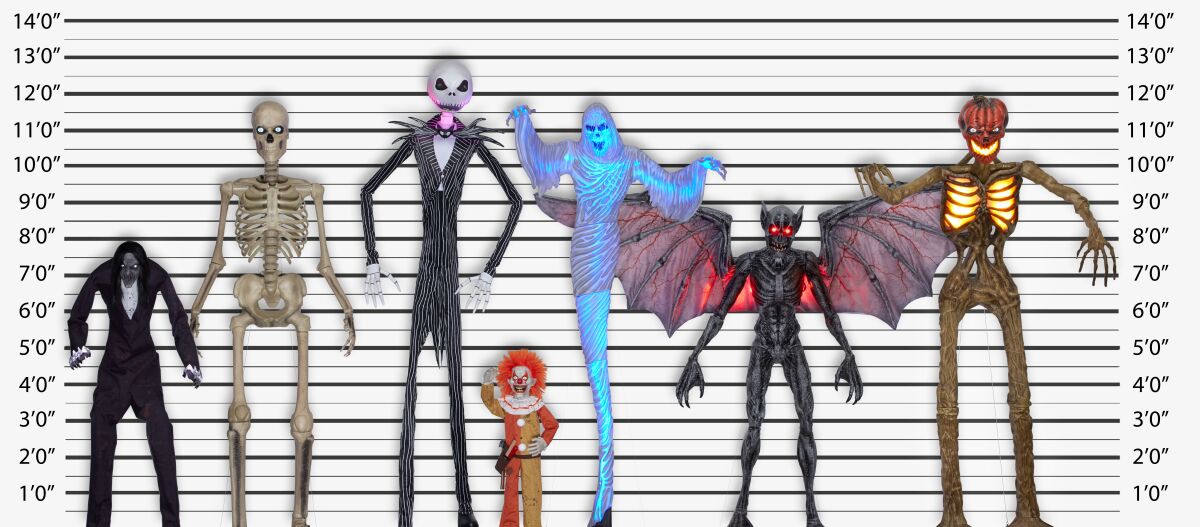 Seven front-yard monsters for Halloween are lined up on a height chart.