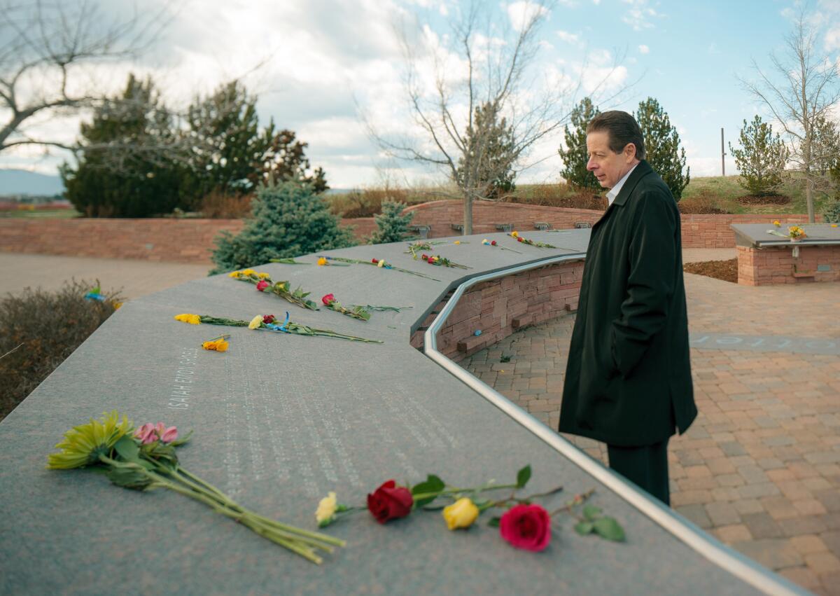 Bill Oudemolen, former pastor of Foothills Bible Church in Littleton, Colo., visits the Columbine Memorial this week. Twenty years ago, Oudemelon presided over the funeral for John Tomlin, who was killed in the Columbine High School shooting.