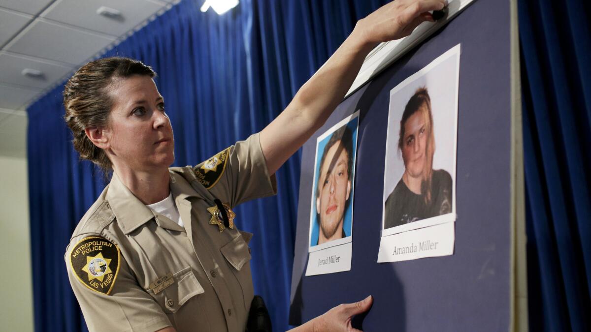 Las Vegas Metropolitan Police Department Officer Laura Meltzer posts photos ofJerad and Amanda Miller before a news conference on June 9, 2014.