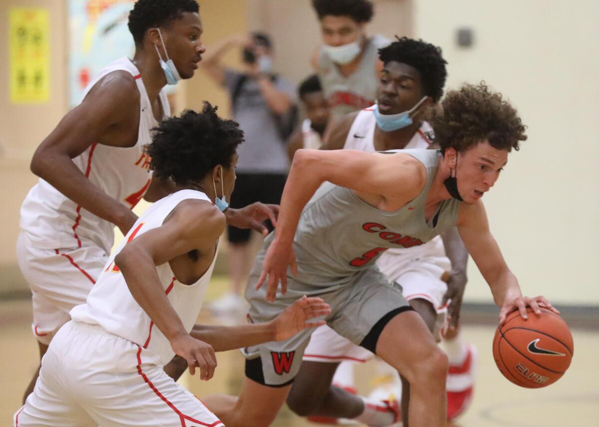 Westchester's TJ Wainwright, right, is surrounded by Fairfax players as he drives to the basket.