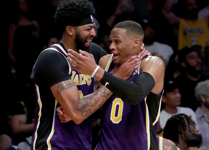 Lakers teammates Anthony Davis, left, and Russell Westbrook celebrate after beating the Cleveland Cavaliers on Friday.