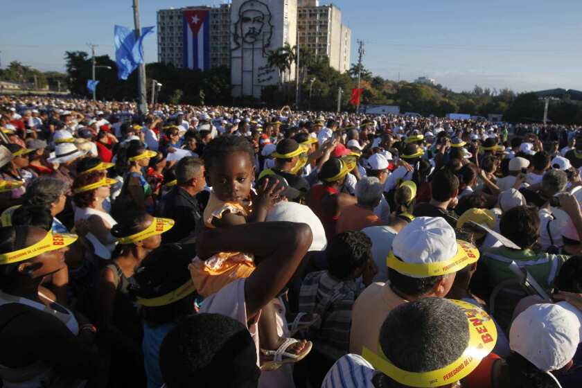 Pope Benedict XVI celebrated Mass in Havana's Plaza de la Revolucion on Wednesday morning. Thousands turned out for the ceremony, many from countries throughout Latin America. A young girl is held above the crowd at the beginning of the service.