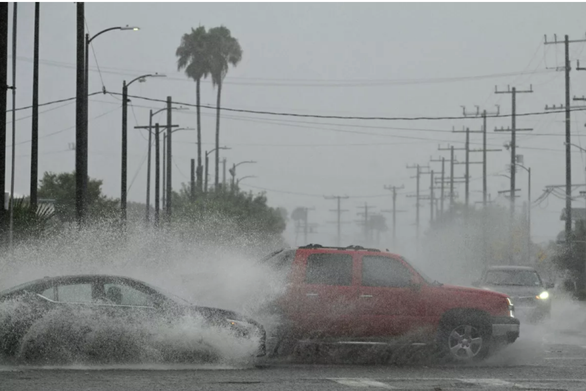 Los vehículos salpican agua durante las fuertes lluvias 