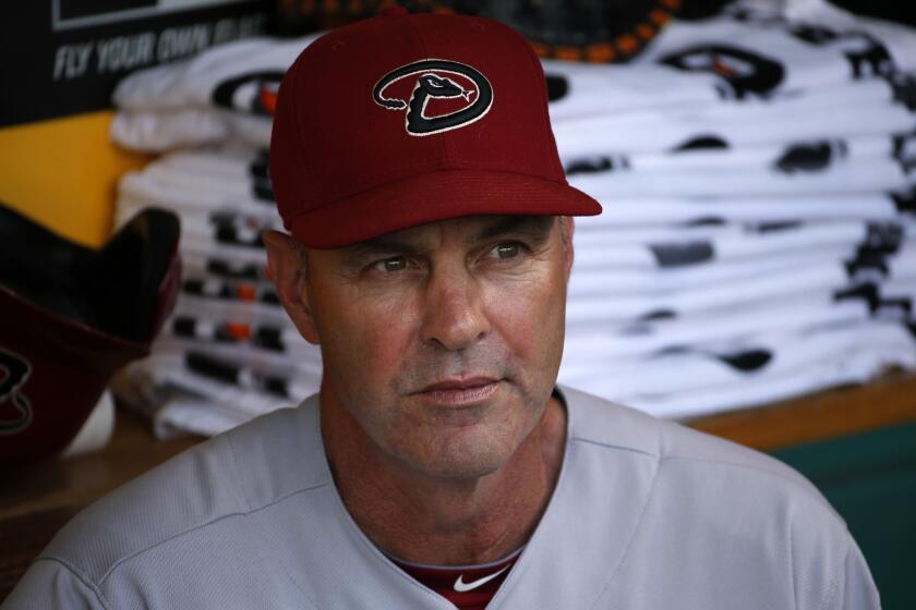 Kirk Gibson sits in the Arizona Diamondbacks dugout before a game July 3, 2014.