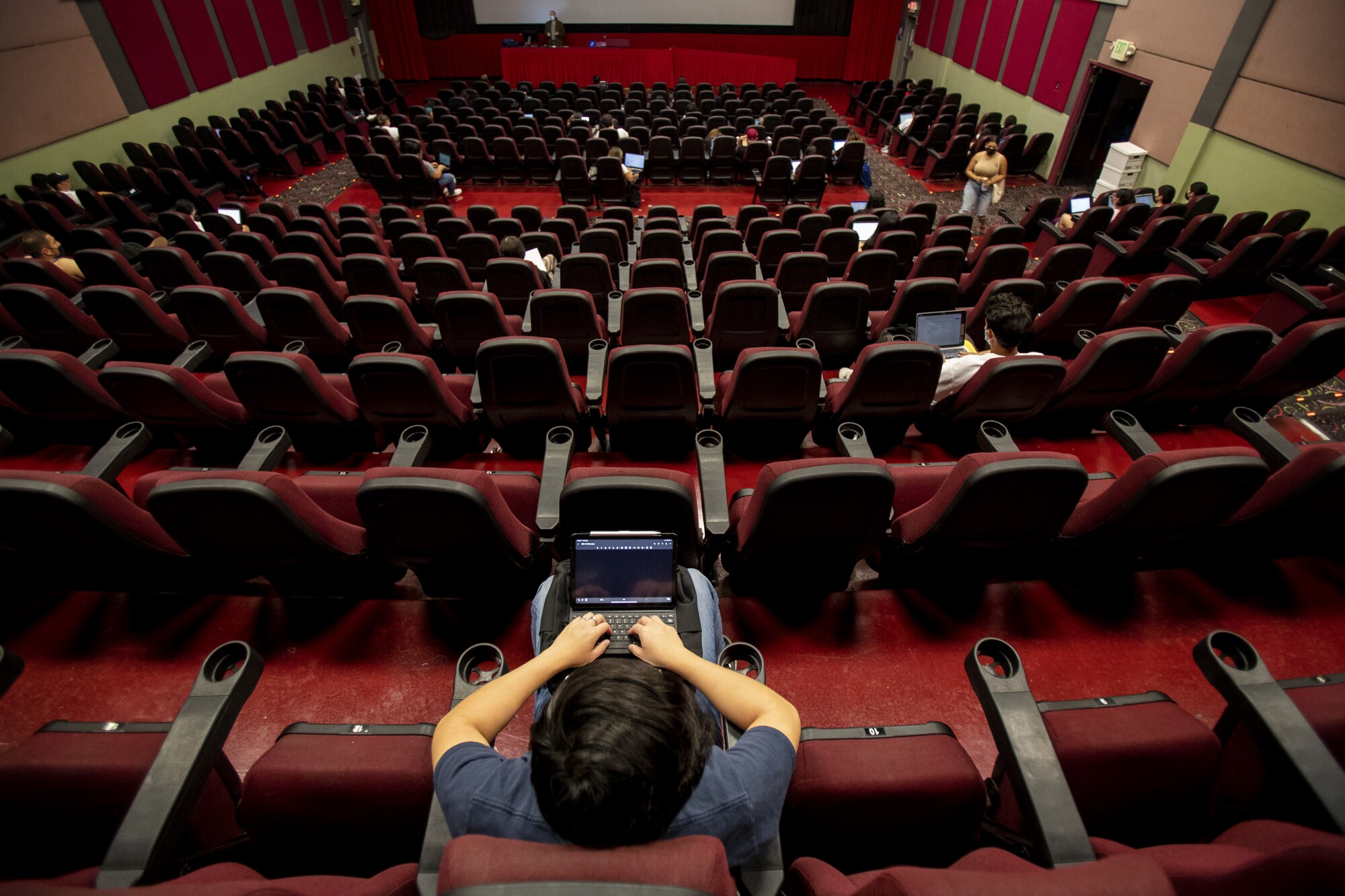College students attend a class inside a movie theater