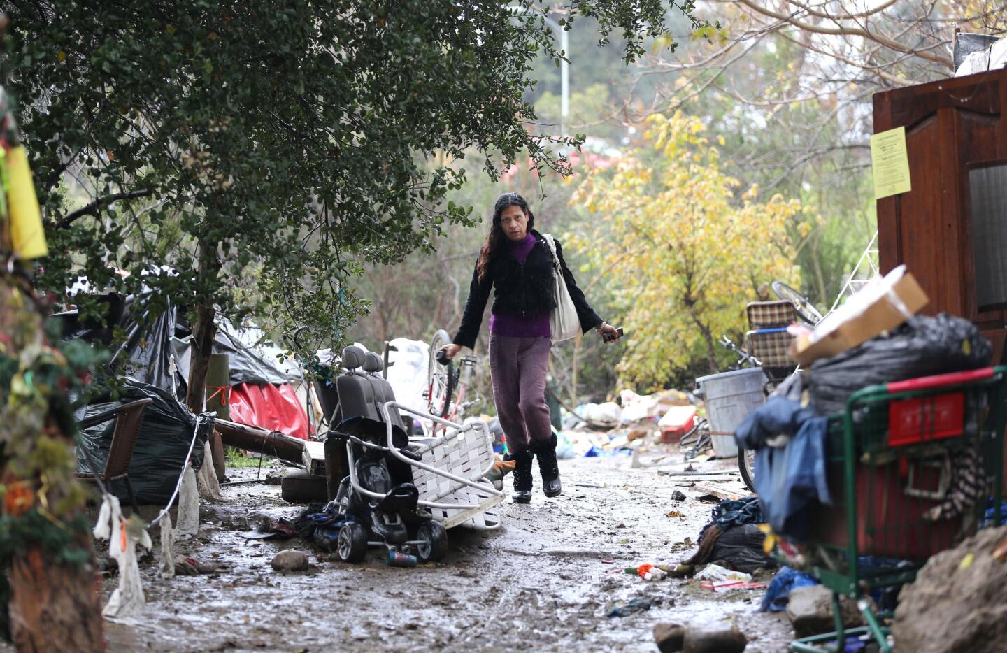 A person walks along a muddy path at the Silicon Valley homeless encampment known as "The Jungle" on December 3, 2014 in San Jose, California.