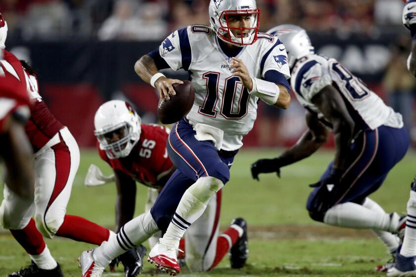 Patriots quarterback Jimmy Garoppolo (10) scrambles against the Arizona Cardinals during the second half.