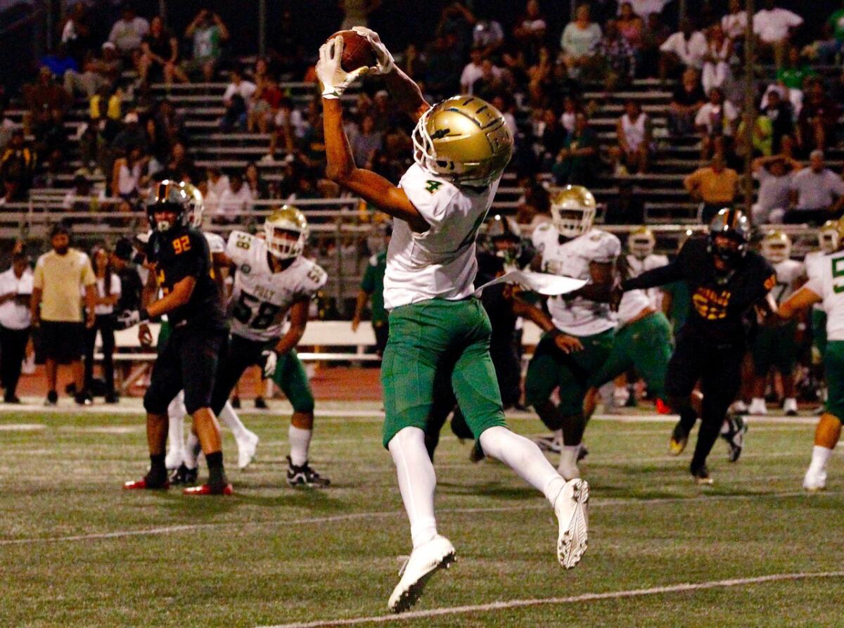 Long Beach Poly wide receiver Jason Robinson makes a catch in the flat against Mission Viejo on Friday night.
